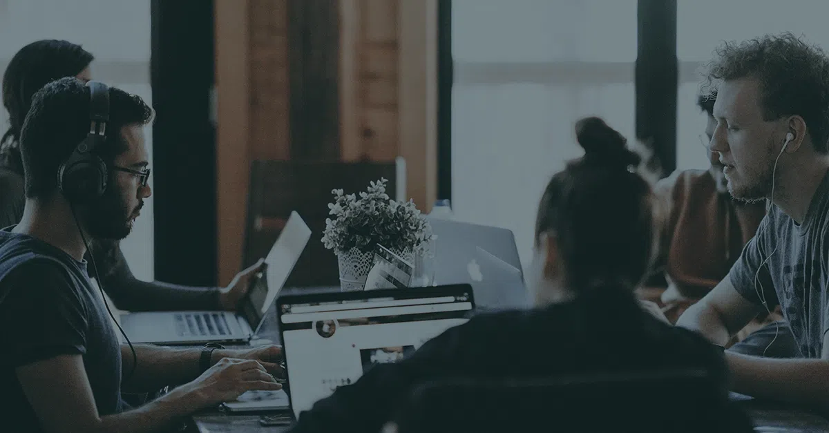 group of people in shared office space on calls
