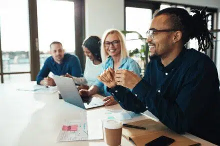 Young African American businessman laughing during an office mee