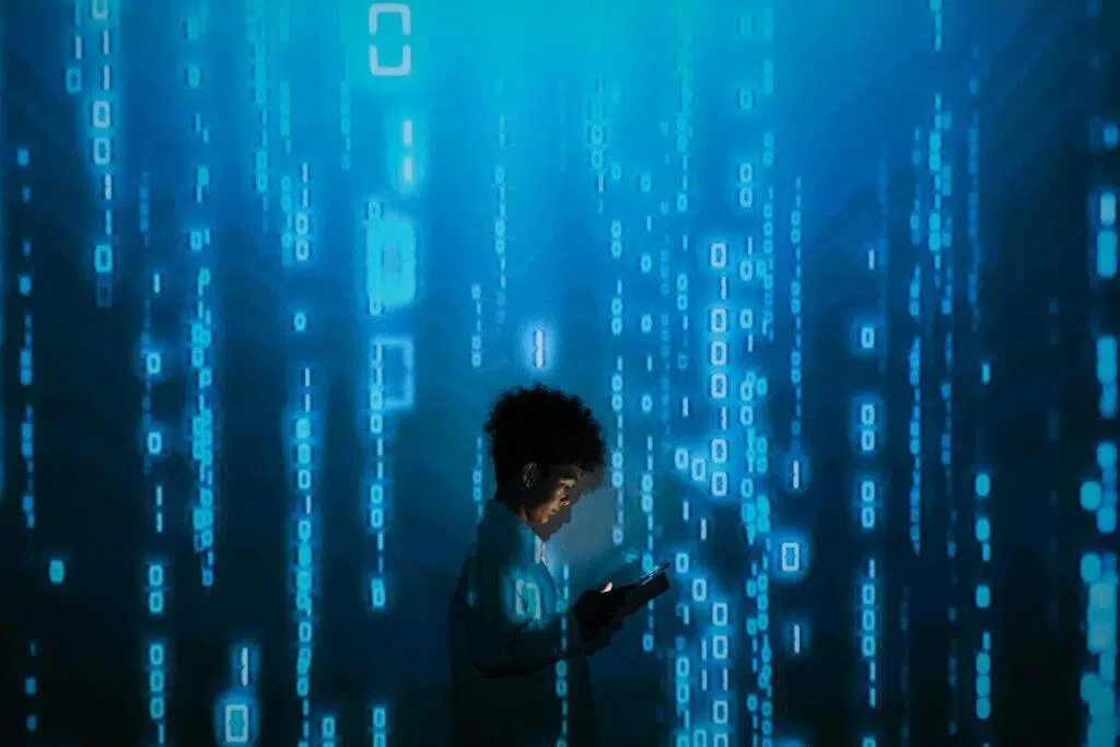 Male looking down at mobile phone with AI themed background