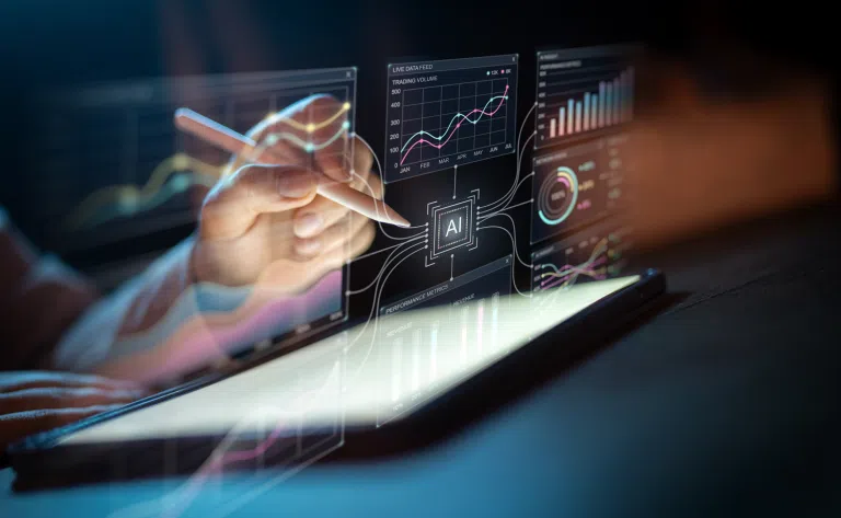 Close-up of a hand using a stylus on a tablet, with floating AI dashboards showing charts, graphs, performance metrics and data visualisations against a dark background.