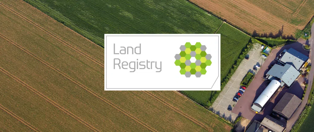 Promotional banner featuring Version 1 and HM Land Registry partnership, showing an aerial view of a suburban area beneath a blue sky. The image highlights HM Land Registry's data modernisation programme delivered in collaboration with Version 1.