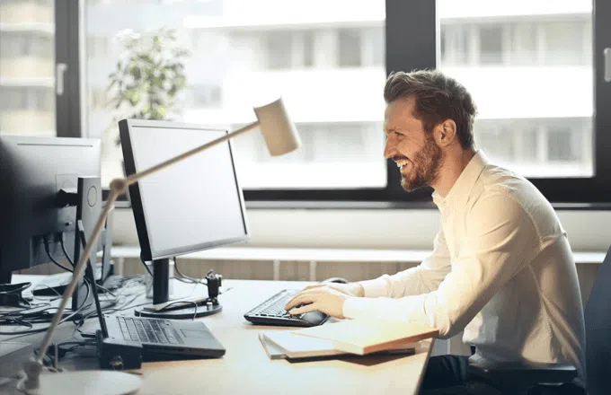 man in office working at laptop