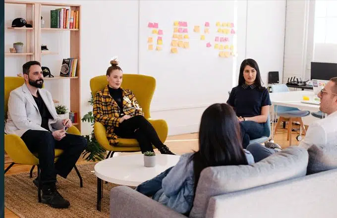group of people talking in a meeting in modern workspace