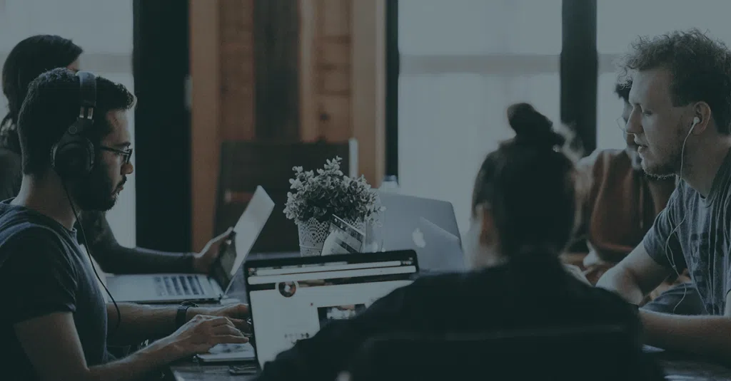 group of people in shared office space on calls