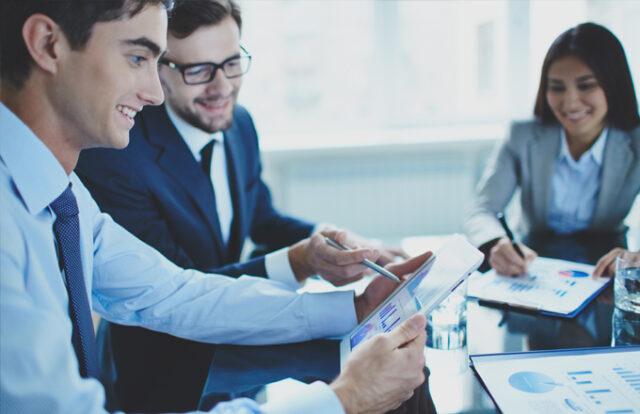 people in a meeting with tablets