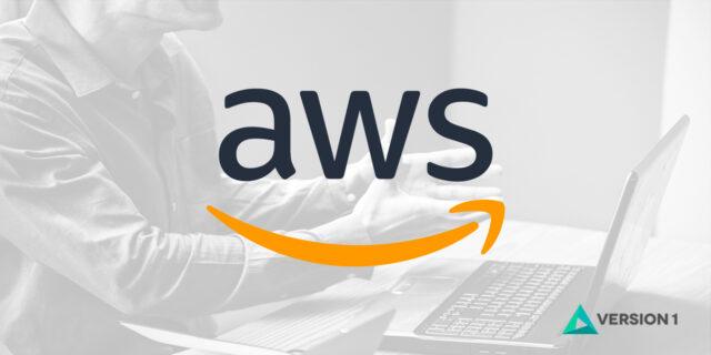 AWS logo laid over an image of hands at a laptop