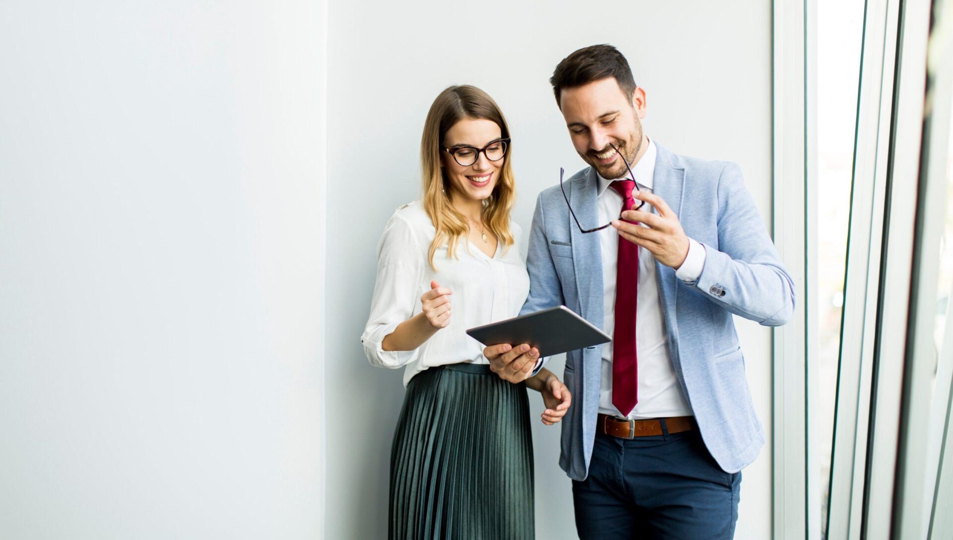 Two people looking at a tablet together