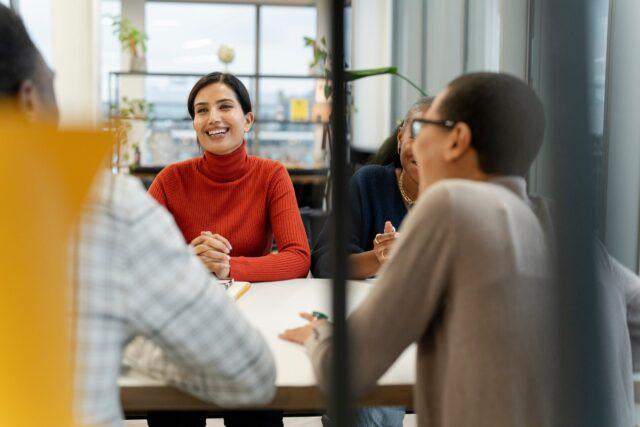 Four people around a desk