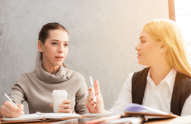 2 people talking and talking notes