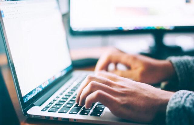 hands at a laptop