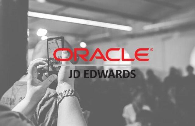 Someone taking a photo on their phone with Oracle logo over image