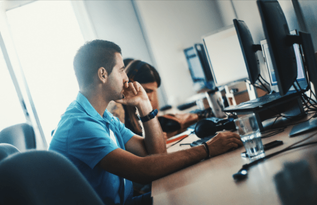 man in office working at laptop