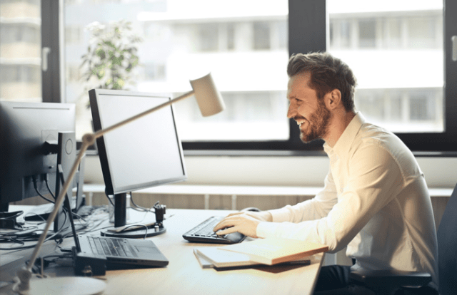man in office working at laptop