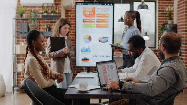 A group of people in an office working colabouratively