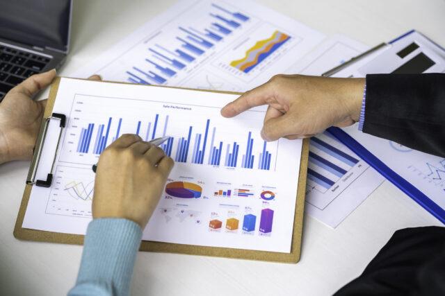hands pointing at graphs
