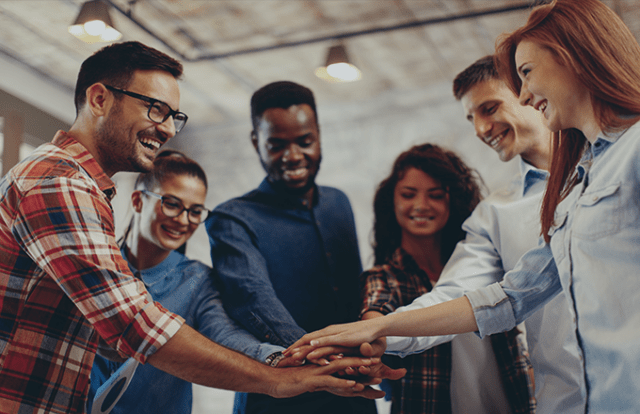 A group of people putting their hands together