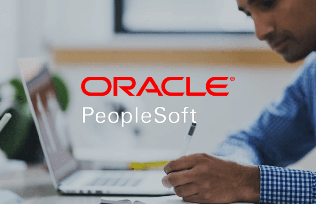 Oracle logo over person sat working on laptop