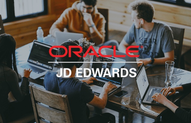 People on laptops around a table with ORACLE logo