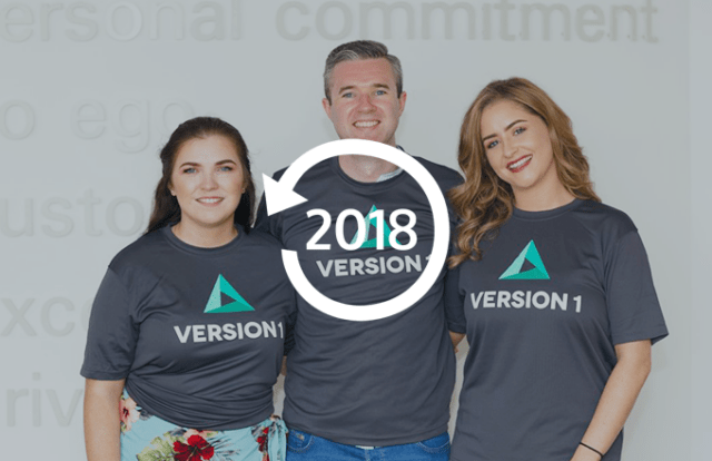 Three people in Version 1 t-shirts