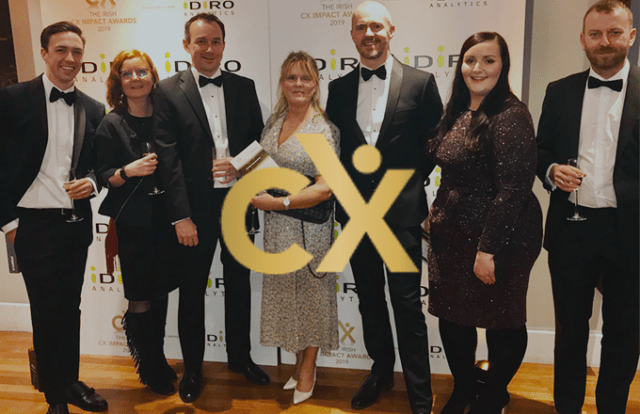 CX logo and group of people holding an award