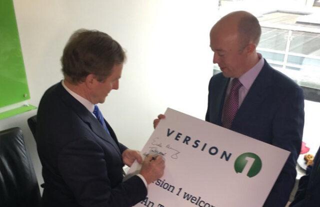 2 men signing a version 1 board