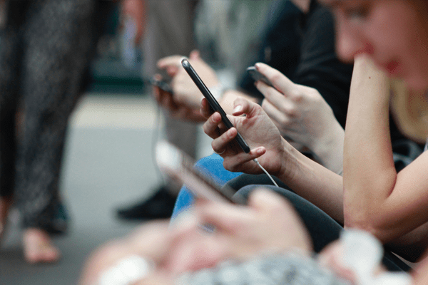 lots of people looking at their phones