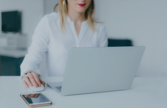 A woman at a desk with a laptop