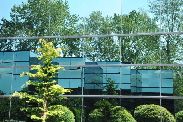 modern building with trees reflected in mirrored walls