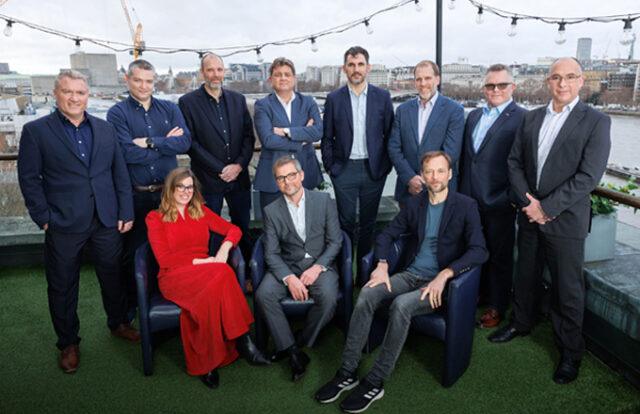 11 people sat on a terrace dressed smartly