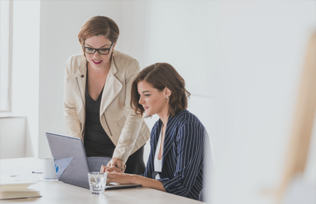 2 people looking at a laptop