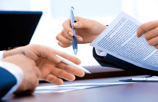 hands holding documents and pens