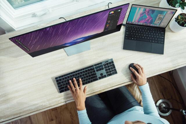 Birds eye view of a persons hands at a keyboard and mouse