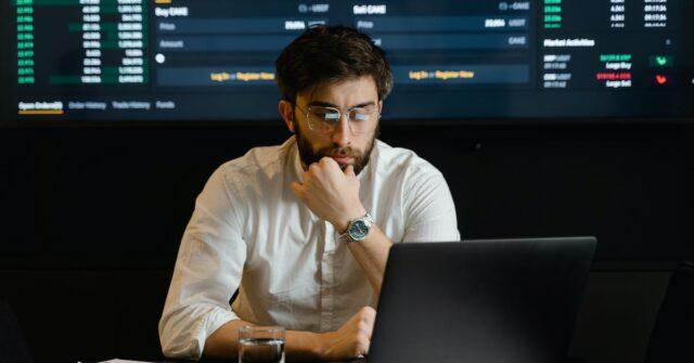 man at desk looking at screen