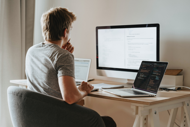 Man coding at desk