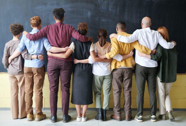 group of people with their arms around each other