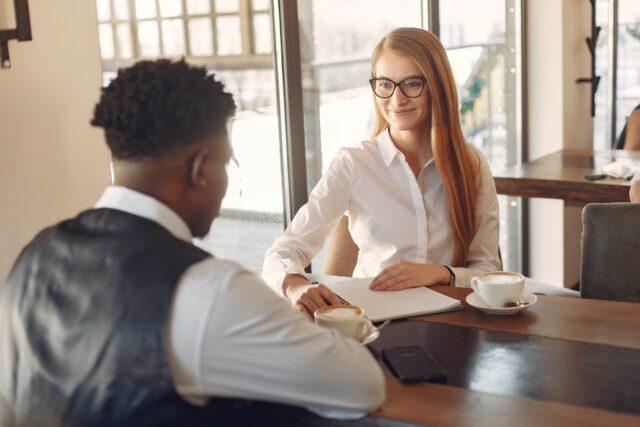 2 people talking across a table