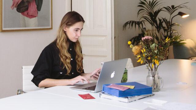 A lady at a desk on a laptop