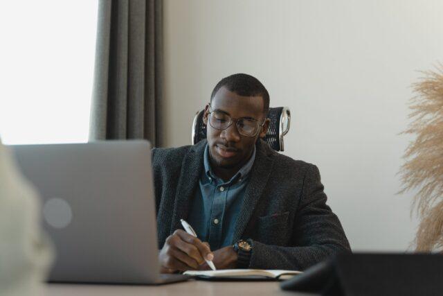 Man sat at a desk using a laptop