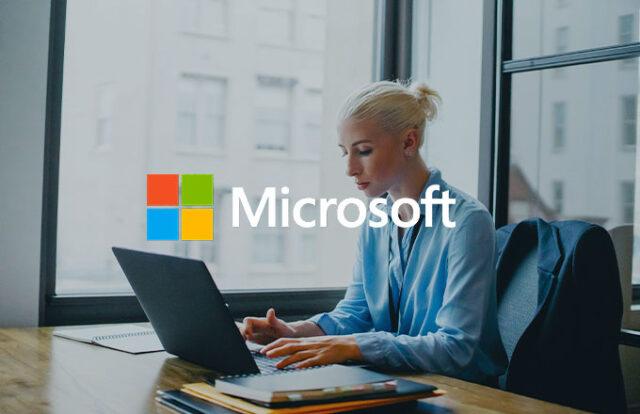 Woman at a laptop with Microsoft logo