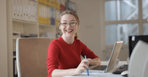Woman smiling at desk.