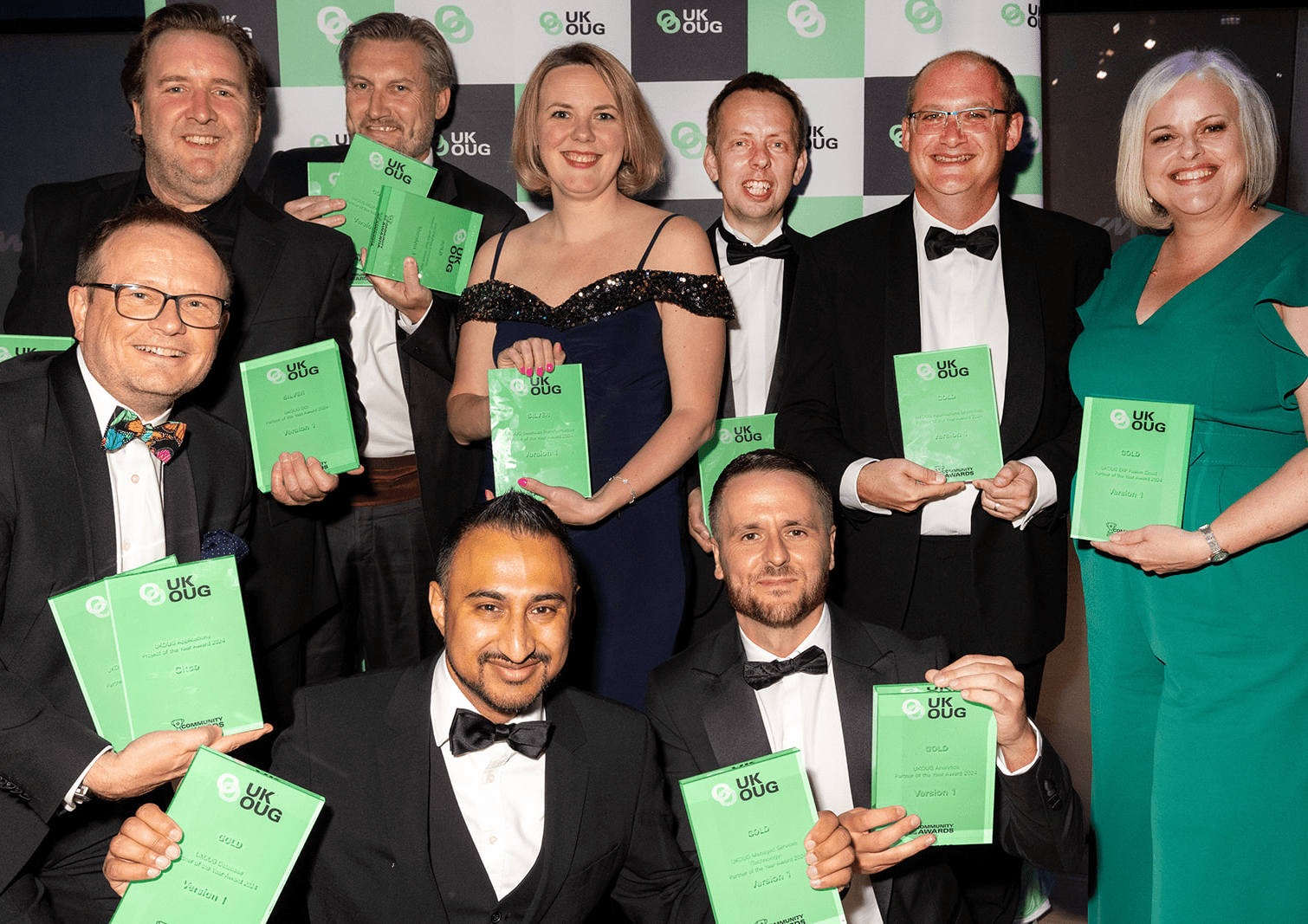 group of Version 1 employees at the award ceremony, holding the awards from UK OUG