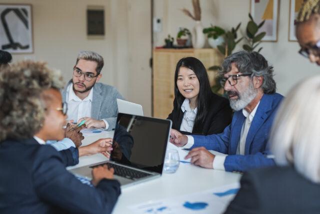 Multiracial business people working inside meeting room office