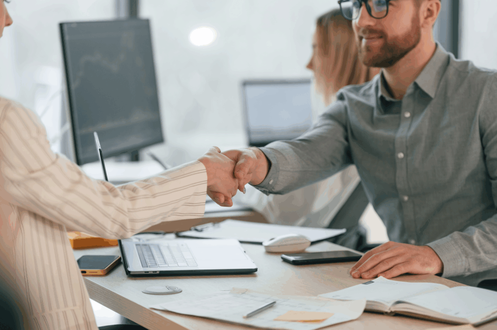 man-and-woman-is-working-together-shaking hands in an office setting