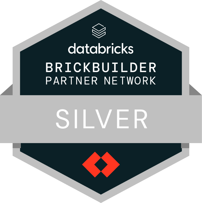 A Databricks badge displaying &ldquo;Brickbuilder Partner Network &ndash; Silver.&rdquo; The badge is hexagon-shaped with dark and light grey sections, the Databricks logo at the top, and a red geometric icon at the bottom.