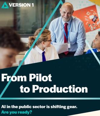 A promotional graphic featuring a classroom scene. A person wearing a light blue shirt, red tie, and lanyard is standing at the front of the room holding papers, with several students seated nearby at desks. The background includes colorful classroom displays, including a large red board with various items attached. Overlaid on the image is a teal geometric line forming a triangular frame. The lower portion of the graphic contains a dark banner with the bold white text “From Pilot to Production.” The top left corner displays the logo and name “Version 1.” Subtle binary‑style digits are also overlaid across the design.