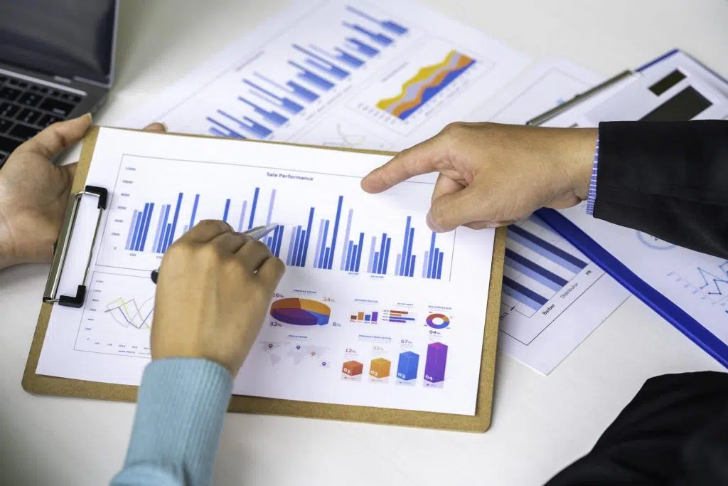 hands pointing at graphs