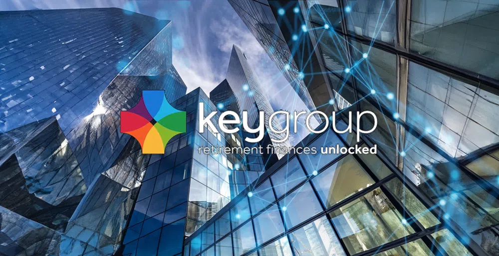 Key Group logo displayed over a background of modern glass office buildings with a digital network overlay of connected nodes and lines, symbolising technology and innovation. The image includes the Key Group branding with a multicoloured cross-shaped icon and the tagline “retirement finances unlocked”.