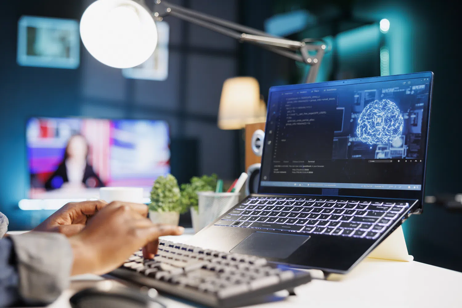 Professional using a laptop displaying AI technology and code in a modern office environment.